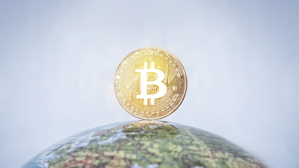 Bitcoin on top of globe